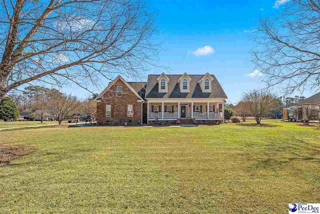 new england style home featuring a front lawn and a porch