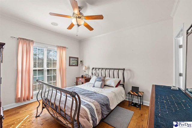 bedroom with crown molding, light wood-style flooring, and baseboards