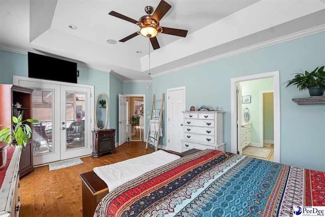 bedroom with access to outside, french doors, a raised ceiling, and crown molding