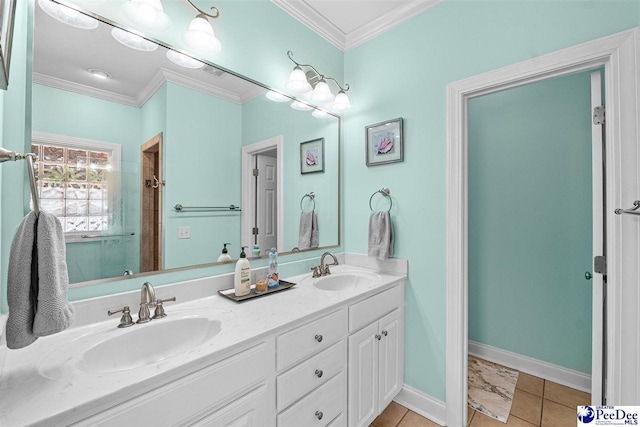 bathroom featuring double vanity, ornamental molding, a sink, and baseboards