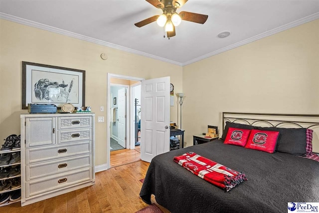 bedroom with ceiling fan, ornamental molding, and wood finished floors