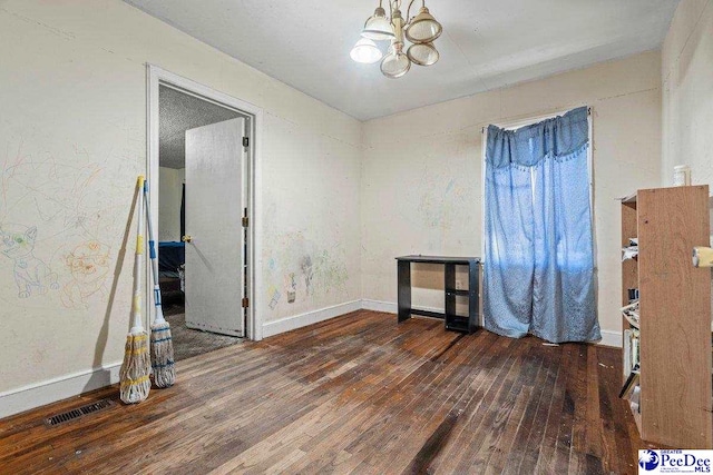 517 Alane St, Lake City, SC 29560 - empty room with baseboards, visible vents, a notable chandelier, and hardwood / wood-style flooring