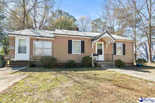 517 Alane St, Lake City, SC 29560 - view of front of property with a front lawn and metal roof