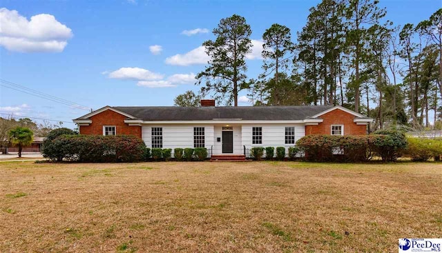 ranch-style house with brick siding and a front yard