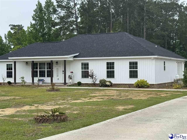 3719 Pine Haven Dr, Florence, SC 29506 - view of front of home with a porch, a front lawn, and roof with shingles
