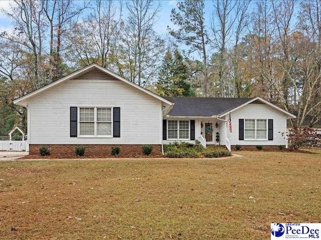 single story home with a front lawn