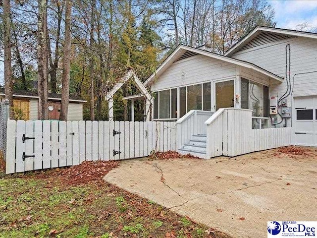 view of property exterior featuring a sunroom