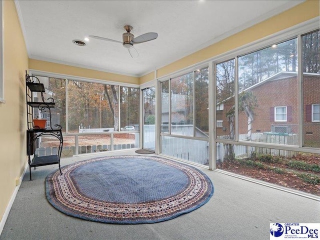 sunroom / solarium with ceiling fan and a wealth of natural light