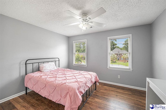 912 Ivanhoe Dr, Florence, SC 29505 - bedroom with wood finished floors, multiple windows, a textured ceiling, and ceiling fan