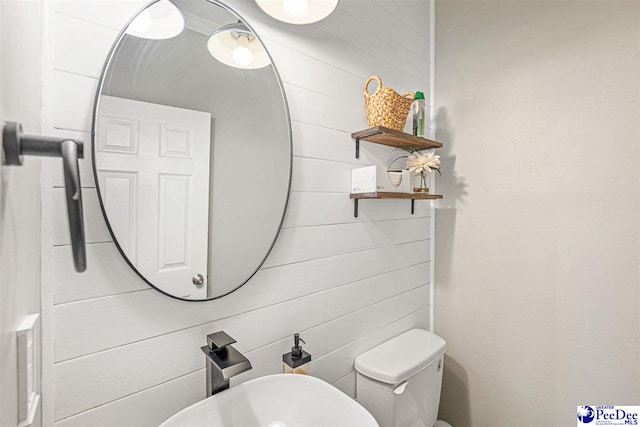 912 Ivanhoe Dr, Florence, SC 29505 - bathroom featuring a sink and wood walls