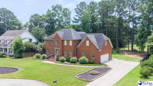 912 Ivanhoe Dr, Florence, SC 29505 - colonial home featuring driveway, a garage, a front lawn, and brick siding