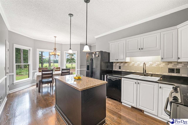 912 Ivanhoe Dr, Florence, SC 29505 - kitchen featuring black appliances, a textured ceiling, dark wood finished floors, white cabinetry, and decorative backsplash
