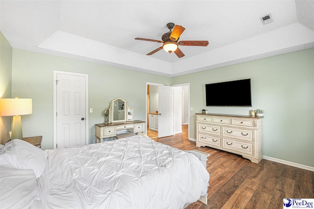 912 Ivanhoe Dr, Florence, SC 29505 - bedroom with a tray ceiling, wood finished floors, and ceiling fan