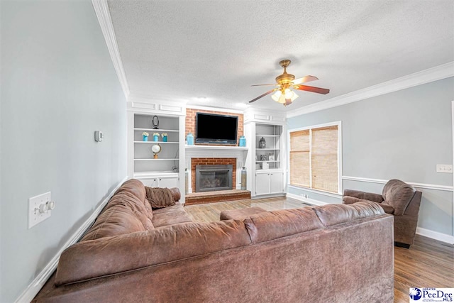 912 Ivanhoe Dr, Florence, SC 29505 - living area with a textured ceiling, ornamental molding, ceiling fan, a brick fireplace, and wood finished floors