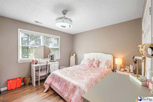 912 Ivanhoe Dr, Florence, SC 29505 - bedroom featuring wood finished floors and a textured ceiling