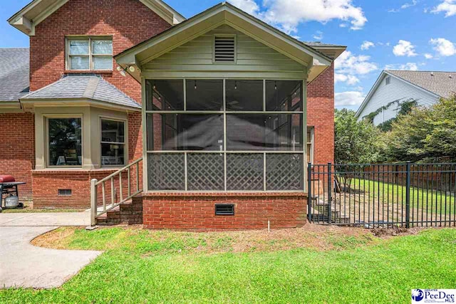 912 Ivanhoe Dr, Florence, SC 29505 - view of front of property featuring a sunroom, crawl space, brick siding, and roof with shingles