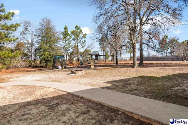 exterior space with playground community and fence