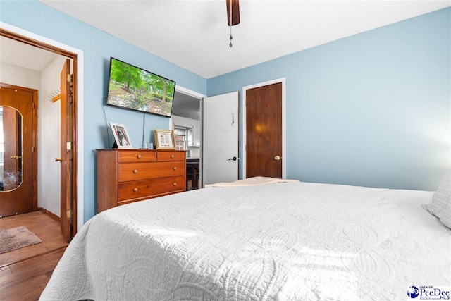 bedroom with wood finished floors and a ceiling fan