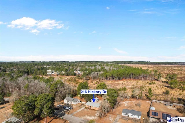 drone / aerial view featuring a view of trees