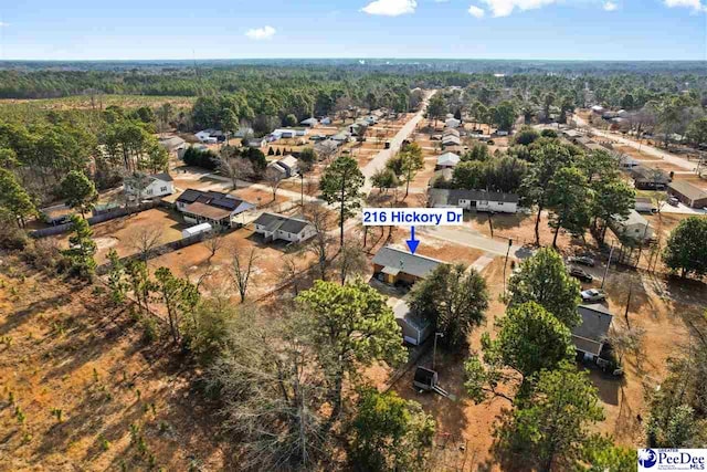 drone / aerial view with a wooded view