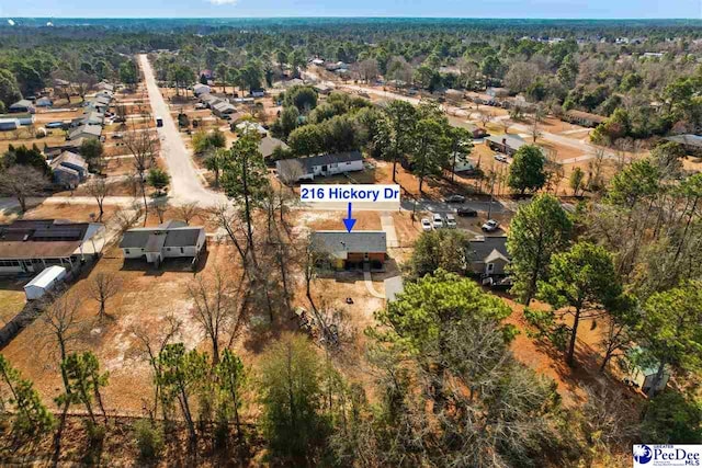 birds eye view of property with a wooded view