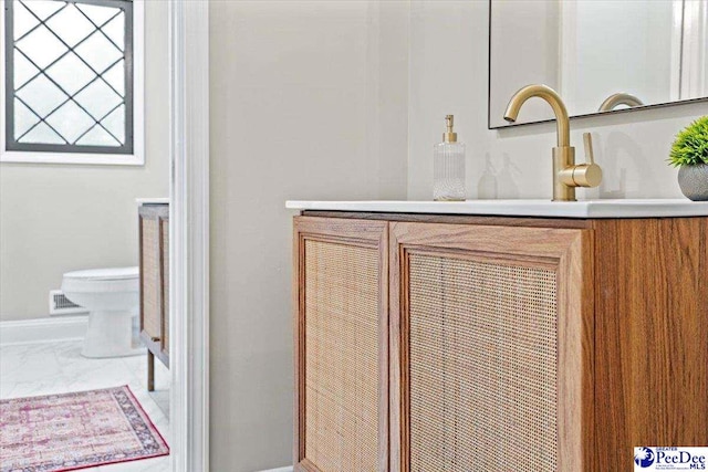 bathroom with vanity and toilet