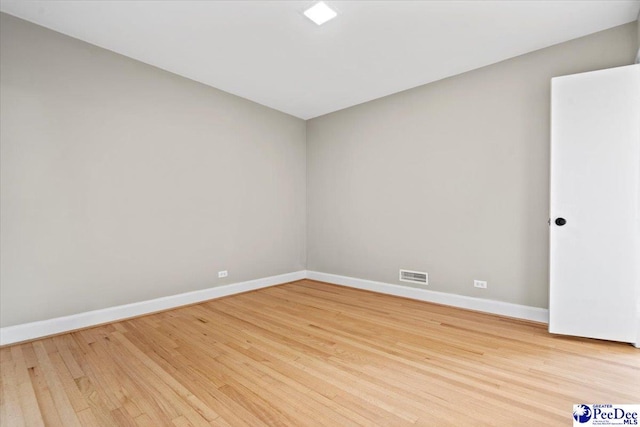 unfurnished room with light hardwood / wood-style floors