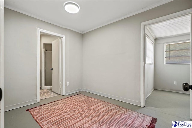 bedroom with crown molding and concrete flooring