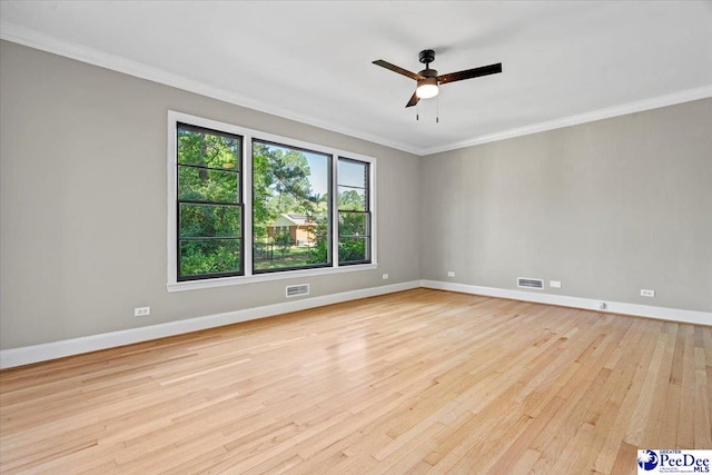 empty room with ornamental molding, ceiling fan, and light hardwood / wood-style floors