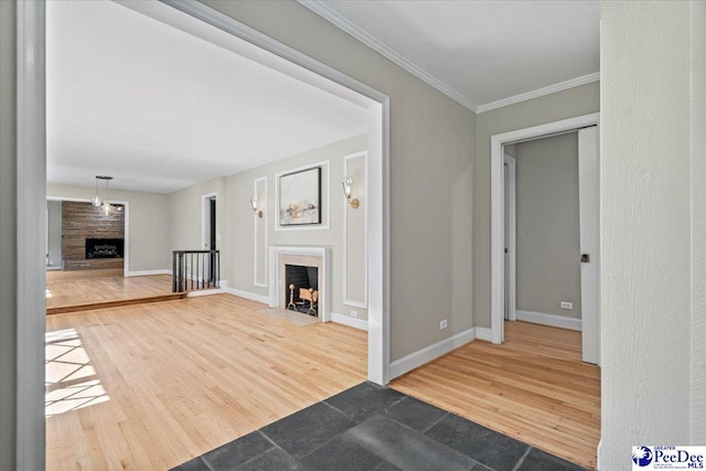 unfurnished living room featuring wood-type flooring and crown molding