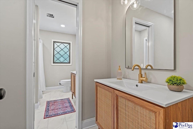 bathroom with vanity and toilet