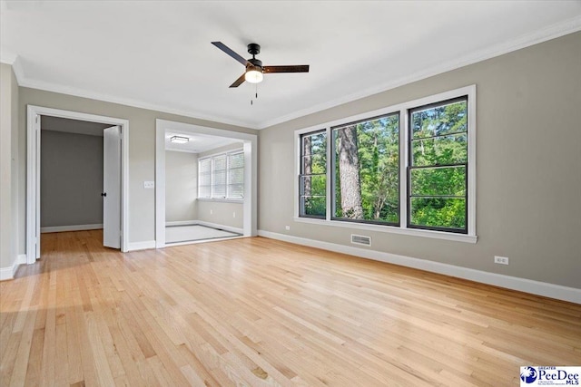 interior space featuring crown molding, ceiling fan, and light wood-type flooring