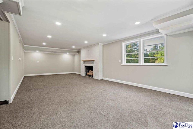 basement featuring crown molding, a fireplace, and carpet flooring