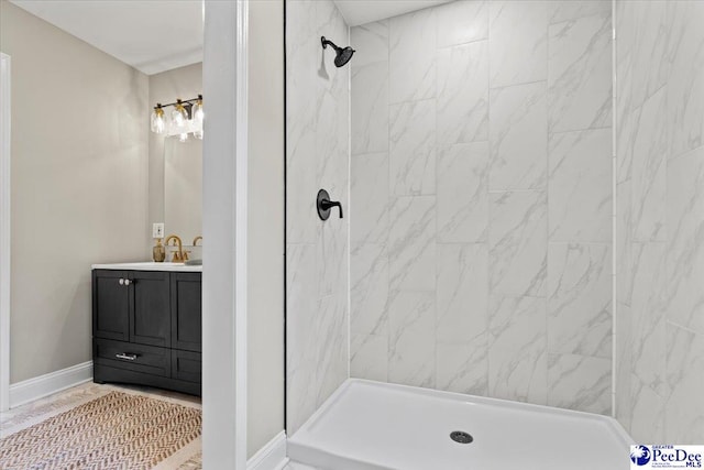 bathroom with vanity and a tile shower