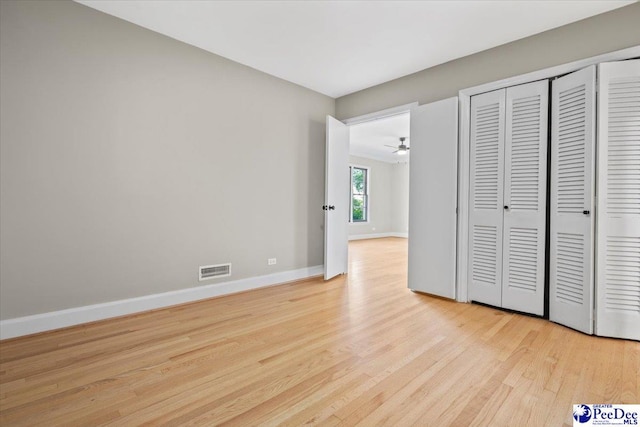 unfurnished bedroom featuring a closet and light hardwood / wood-style flooring