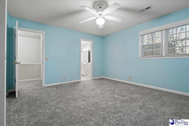 3406 Sussex Ct, Florence, SC 29501 - unfurnished bedroom featuring ceiling fan, carpet floors, connected bathroom, and a textured ceiling