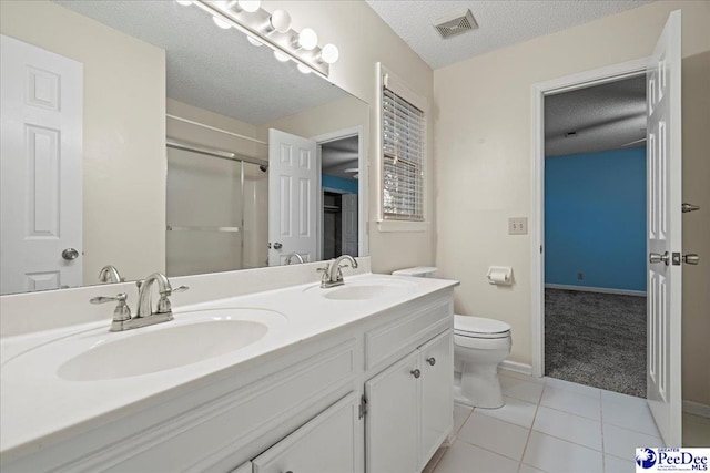 3406 Sussex Ct, Florence, SC 29501 - bathroom with toilet, a shower with shower door, a textured ceiling, vanity, and tile patterned flooring