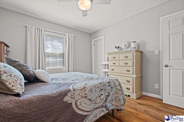 907 Adams Ave, Florence, SC 29501 - bedroom featuring baseboards, ornamental molding, light wood finished floors, and ceiling fan
