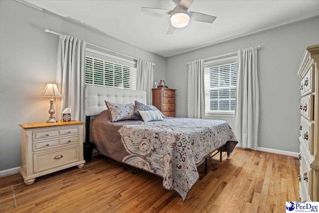 907 Adams Ave, Florence, SC 29501 - bedroom with light wood finished floors, baseboards, ceiling fan, and ornamental molding