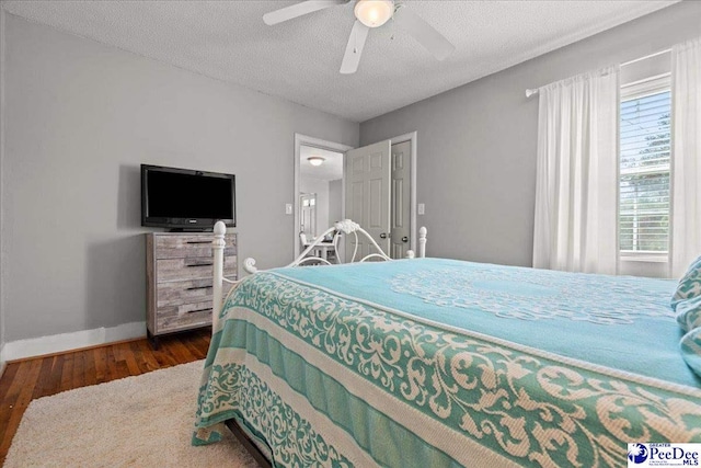 907 Adams Ave, Florence, SC 29501 - bedroom featuring baseboards, a ceiling fan, a textured ceiling, and wood finished floors