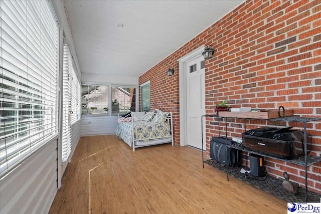 907 Adams Ave, Florence, SC 29501 - bedroom featuring wood finished floors and brick wall