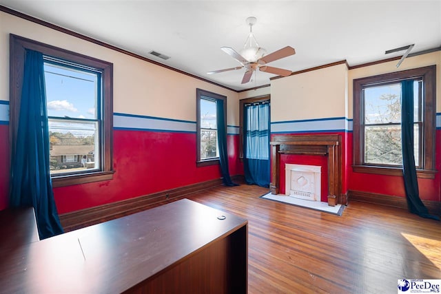 unfurnished living room featuring crown molding, wood-type flooring, and ceiling fan