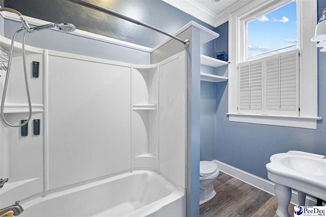 full bathroom with sink, crown molding,  shower combination, wood-type flooring, and toilet