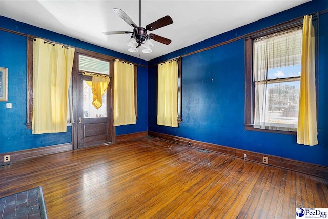 spare room featuring wood-type flooring and ceiling fan