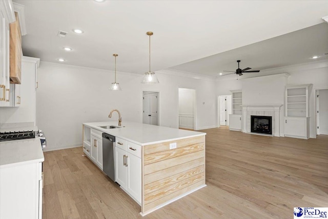 4064 Crest Cv, Florence, SC 29501 - kitchen with a center island with sink, light countertops, white cabinets, a sink, and dishwasher