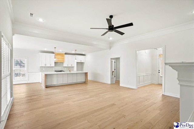 4064 Crest Cv, Florence, SC 29501 - unfurnished living room featuring ornamental molding, visible vents, ceiling fan, and light wood-style flooring