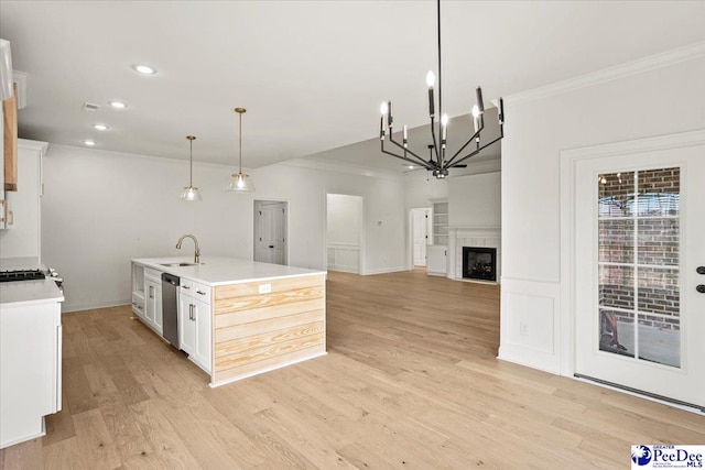 4064 Crest Cv, Florence, SC 29501 - kitchen with a sink, white cabinetry, open floor plan, light countertops, and a center island with sink