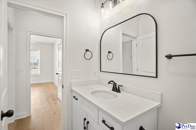 4064 Crest Cv, Florence, SC 29501 - bathroom with vanity, baseboards, and wood finished floors