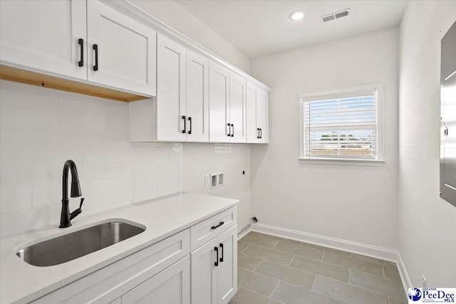 4064 Crest Cv, Florence, SC 29501 - clothes washing area with baseboards, a sink, cabinet space, and hookup for a washing machine