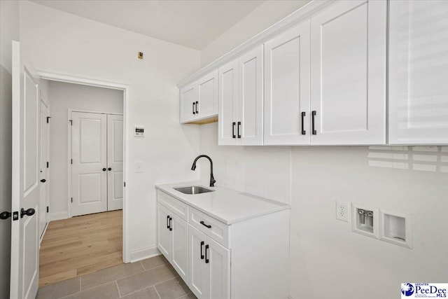 4064 Crest Cv, Florence, SC 29501 - washroom featuring hookup for a washing machine, cabinet space, light wood-style flooring, hookup for an electric dryer, and a sink